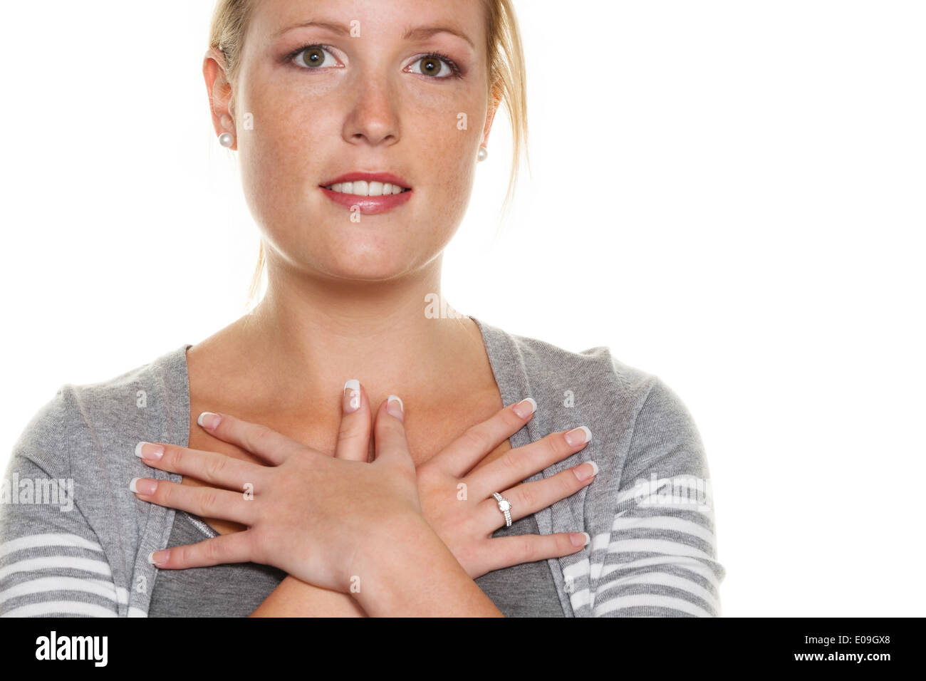 A young woman holds her hands before her body. Symbolic photo fue Schutzbeduefnis, insecurity and thoughtfulness, Eine junge Fra Stock Photo