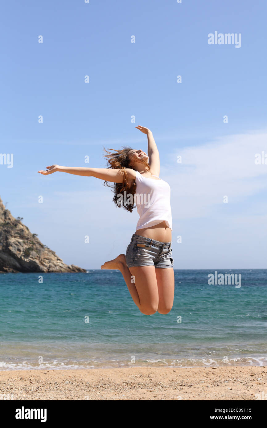 Funny woman jumping on a paradise beach on summer holidays Stock Photo -  Alamy