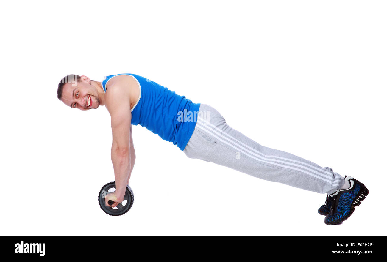 Man exercising fitness workout abdominal toning wheel overwhite background Stock Photo