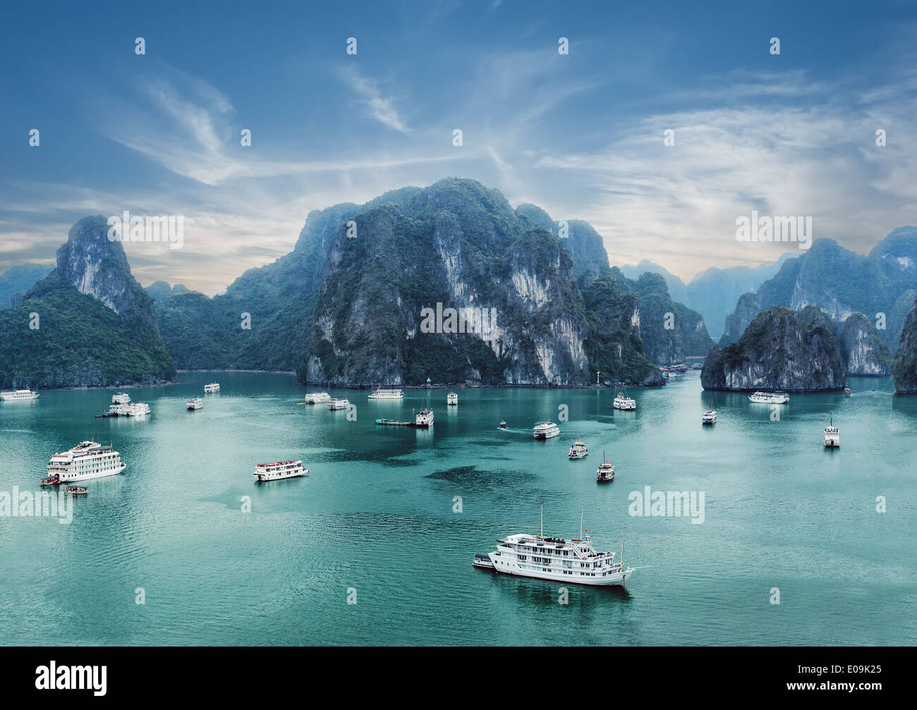 Tourist junks floating among limestone rocks at early morning in Ha Long Bay South China Sea Vietnam Southeast Asia Two images Stock Photo
