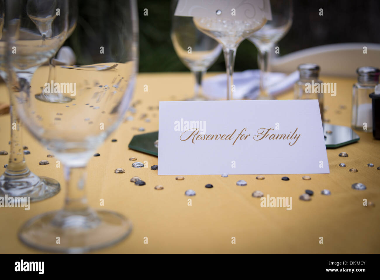Table setting with wine glasses, salt and pepper shakers and a paper