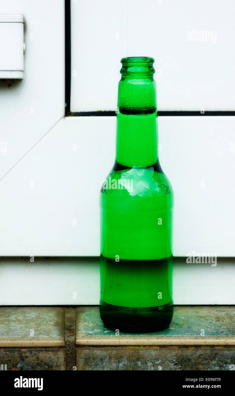 green beer bottle on a doorstep england uk Stock Photo