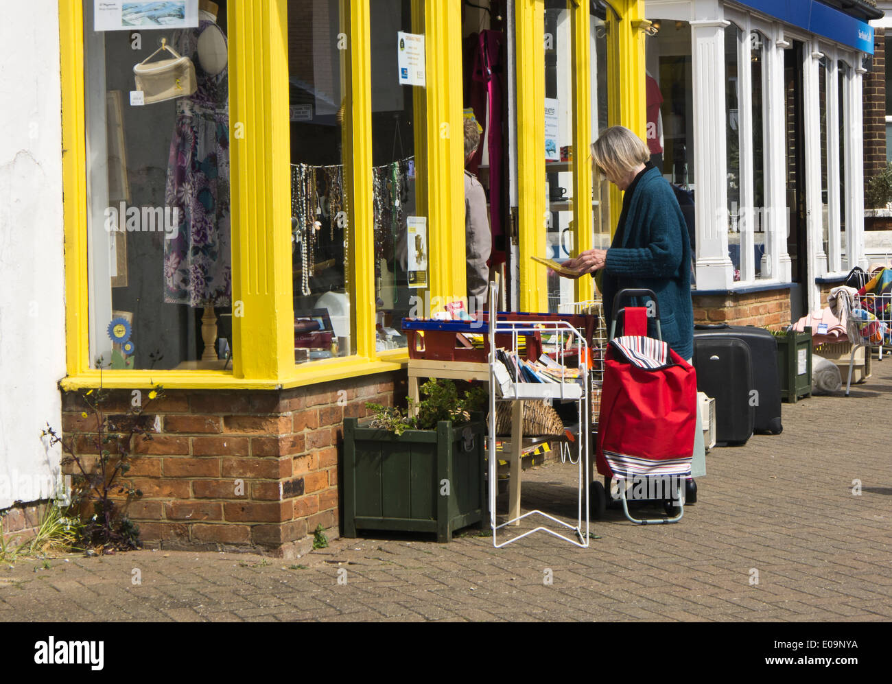 A woman browsing at a charity shop. Stock Photo