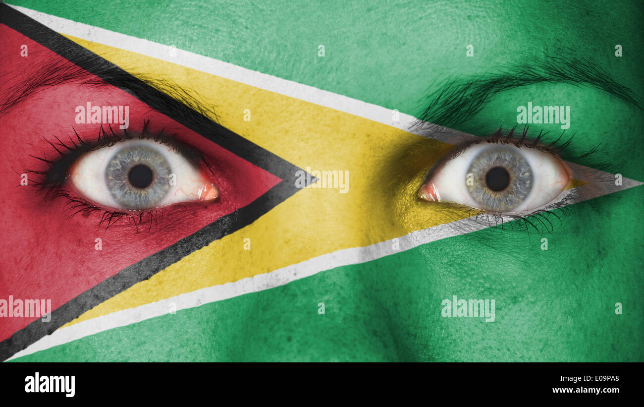 Close up of eyes. Painted face with flag of Guyana Stock Photo