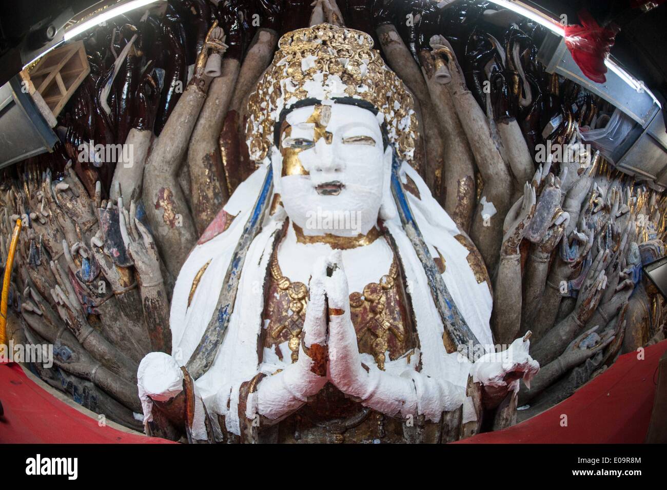 (140507) -- CHONGQING, May 7, 2014 (Xinhua) -- Photo taken on May 7, 2014 shows a sculpture of Qianshou Guanyin (bodhisattva with a thousand hands) on Mount Baoding after restoration in Dazu District in the municipality of Chongqing, southwest China. The sculpture, carved in the cave with 7.7 meters high and 12.5 meters wide, could date back to Southern Song Dynasty (1127 to 1279). Over the centuries, the sculpture's color has faded, parts of the gold foil covering have peeled off, and cracks have appeared. And thus, a restoration project for the Buddhist statue has been launched since April 1 Stock Photo