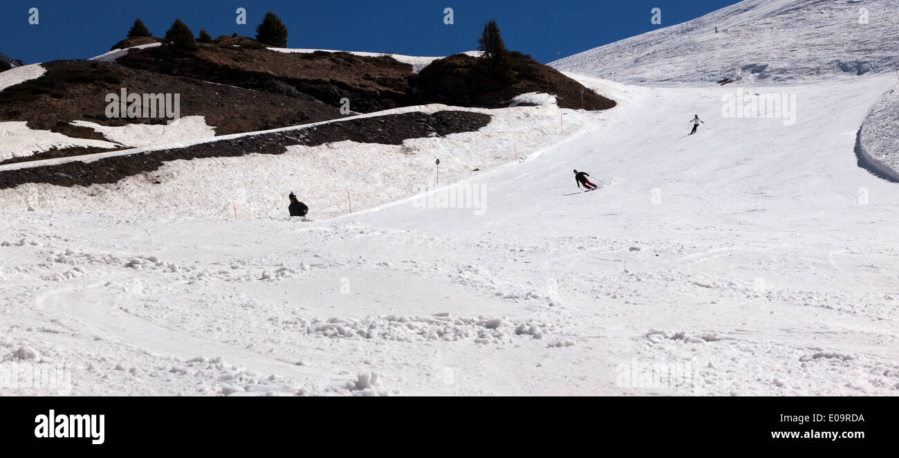 Skiers descending the Arbis red piste in the Alpine ski-resort of Morzine, France. Stock Photo