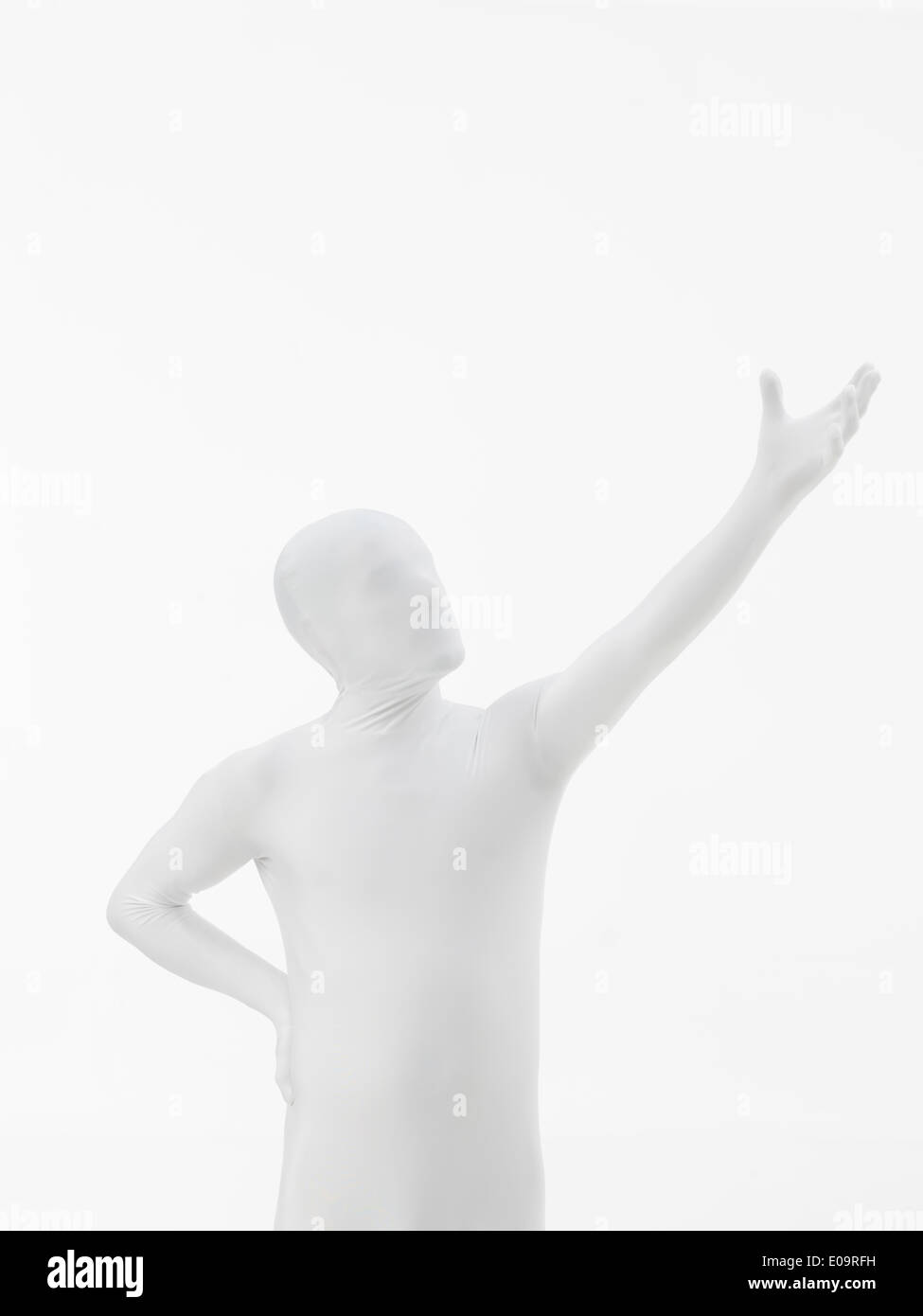 faceless man dressed in white with hand raised up Stock Photo