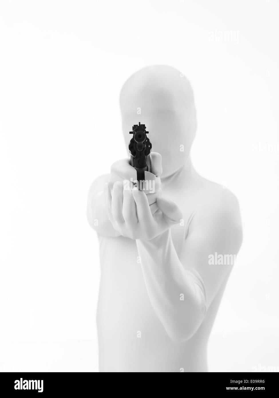 faceless man dressed in white aims gun at you Stock Photo