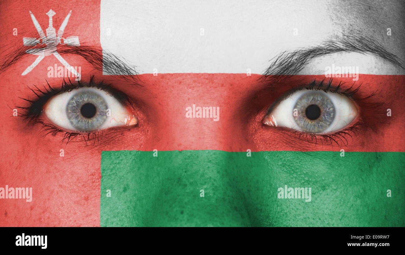 Close up of eyes. Painted face with flag of Oman Stock Photo