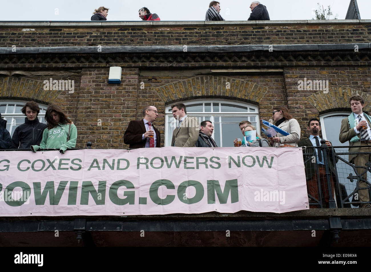 Spectators on the bank of the River Thames at Hammersmith during the annual Oxford and Cambridge Boat Race. Stock Photo