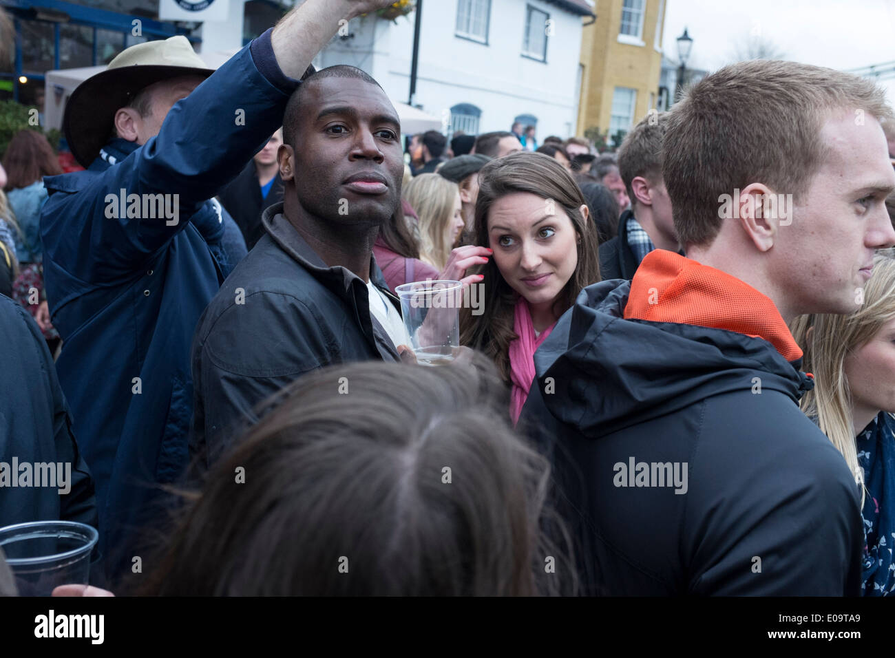 Spectators on the bank of the River Thames at Hammersmith during the annual Oxford and Cambridge Boat Race. Stock Photo