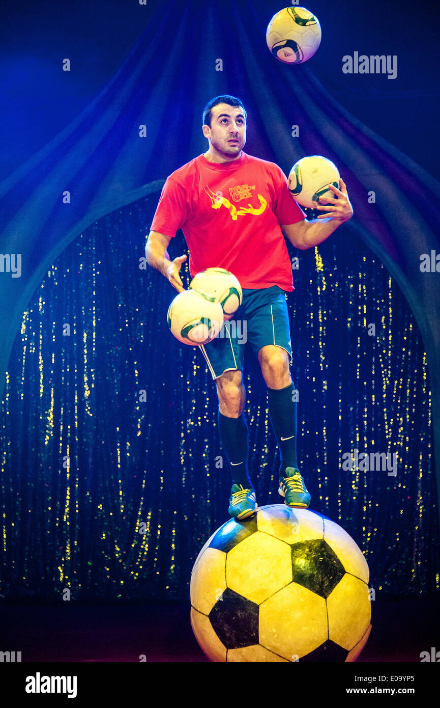 Brighton, UK. 07th May, 2014. Zhora Oganisyan, the football juggler from The Moscow State Circus, breaks the World Record for balancing on a giant football whilst juggling 3 footballs with his hands and ‘keeping up’ a further football by flicking it from foot to foot. The previous record was 36 keepie uppies, which Armenian born Zhora beat by doing 38. The Moscow State Circus is in Preston Park, Brighton as part of the Fringe Festival. Credit:  Julia Claxton/Alamy Live News Stock Photo