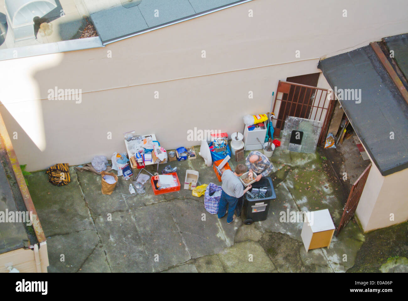 Cleaning out a storage room in courtyard of residential building, Zizkov, Prague, Czech Republic, Europe Stock Photo