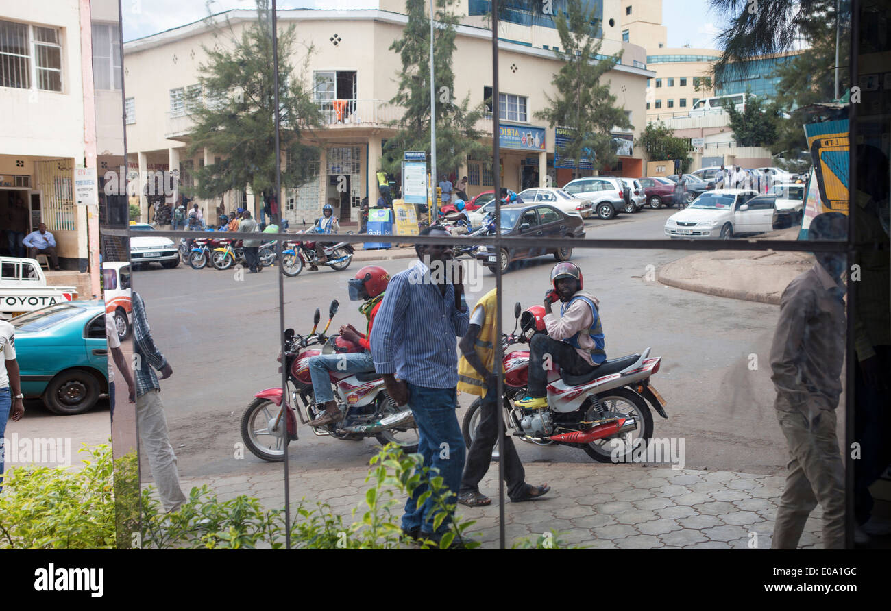 Street scene in downtown Kigali reflected on modern building, Rwanda. Stock Photo
