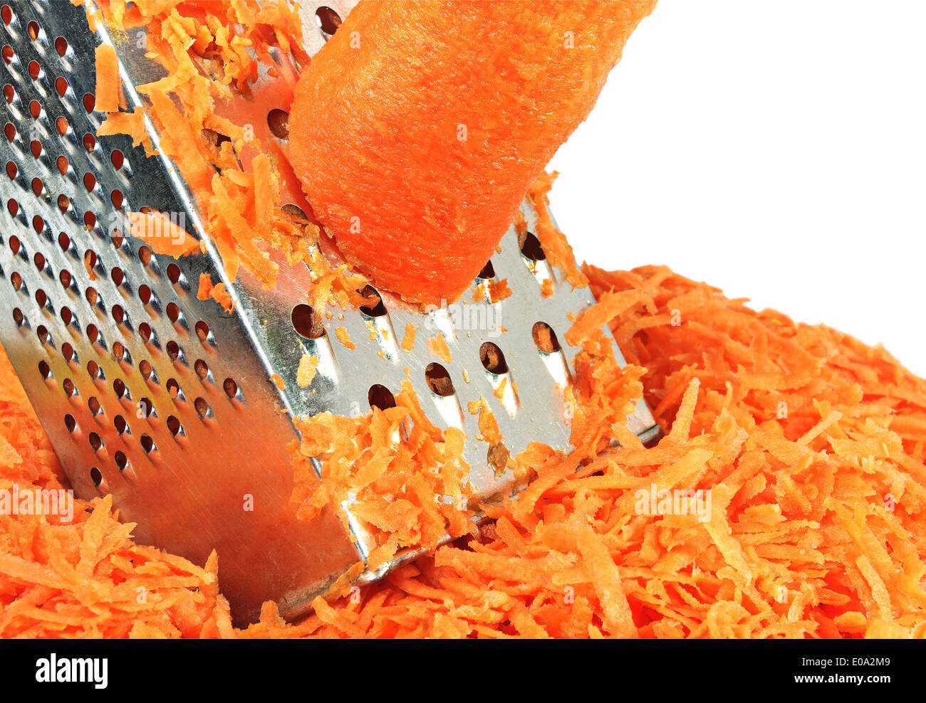 Metal grater and carrot on white background Stock Photo - Alamy