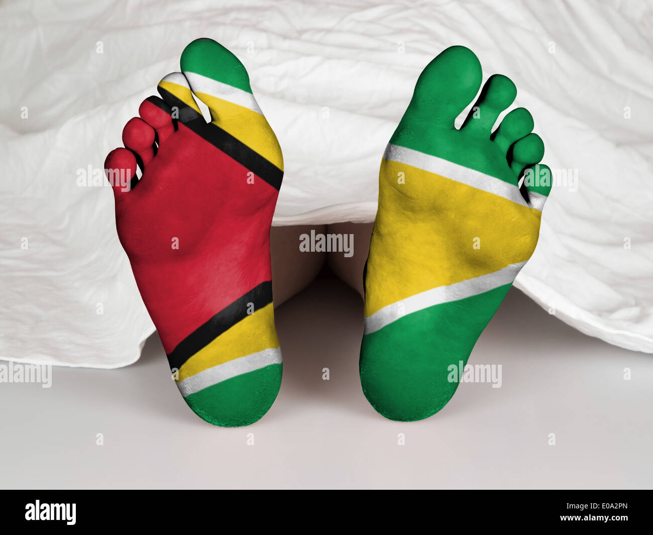 Feet with flag  sleeping or death concept  flag of Guyana Stock Photo