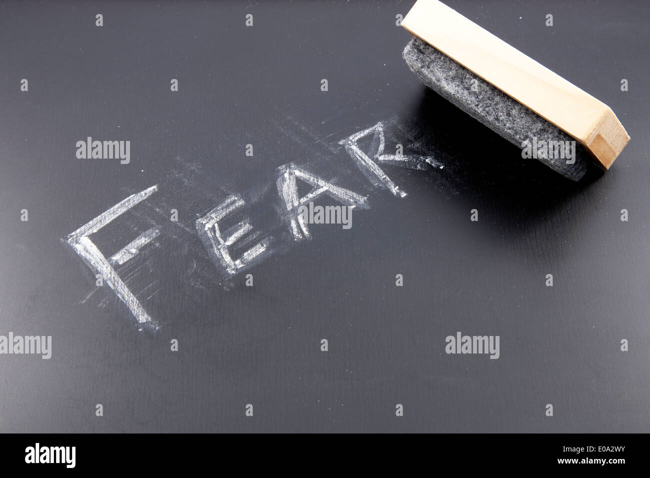 The word FEAR being erased from a chalkboard Stock Photo - Alamy