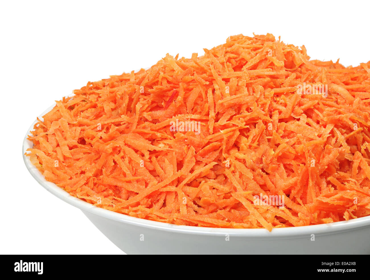 Raw grated carrots on a plate isolated on white Stock Photo Alamy