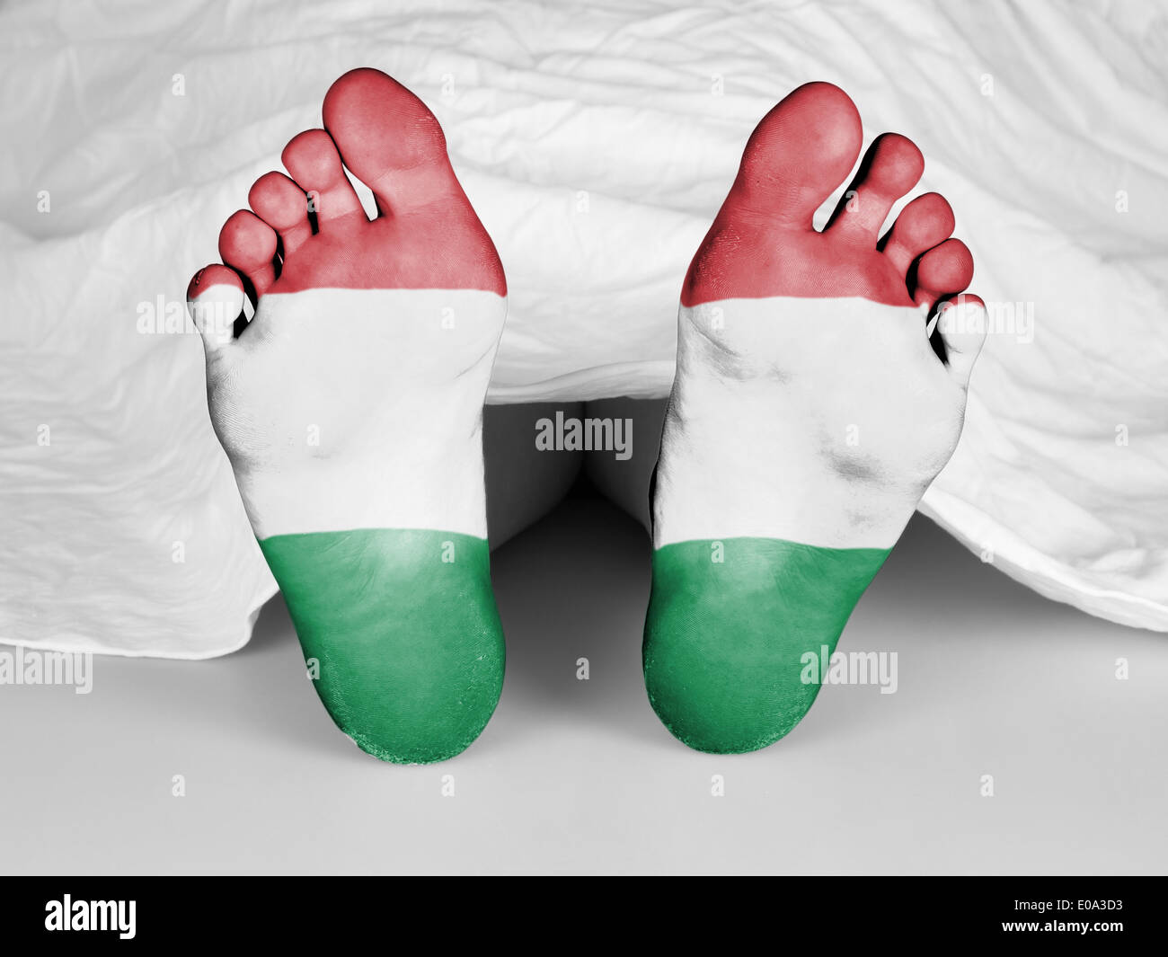 Dead body under a white sheet  flag of Hungary Stock Photo