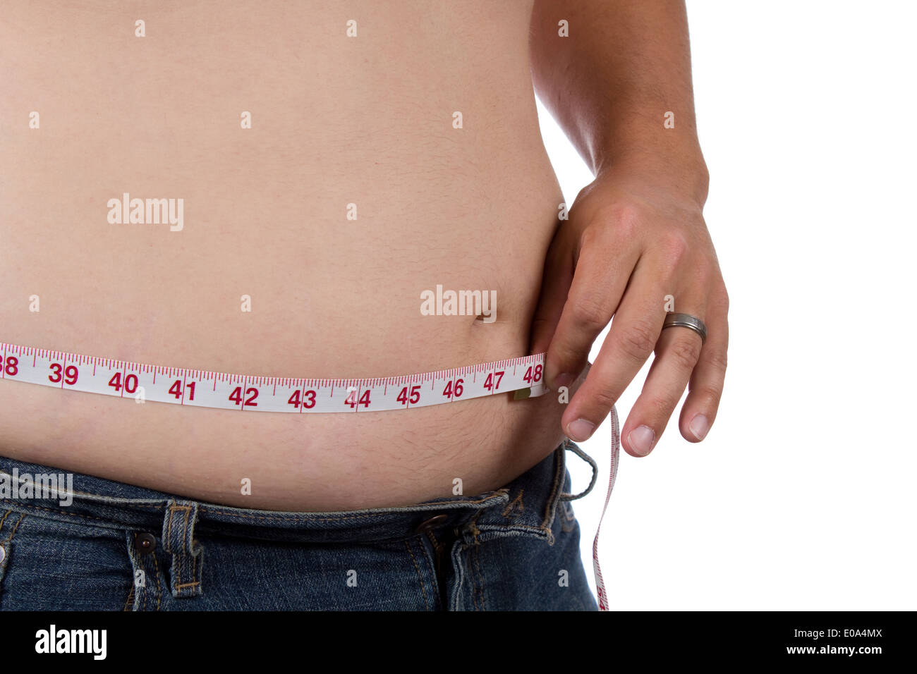 Overweight man measures his waist size. Stock Photo