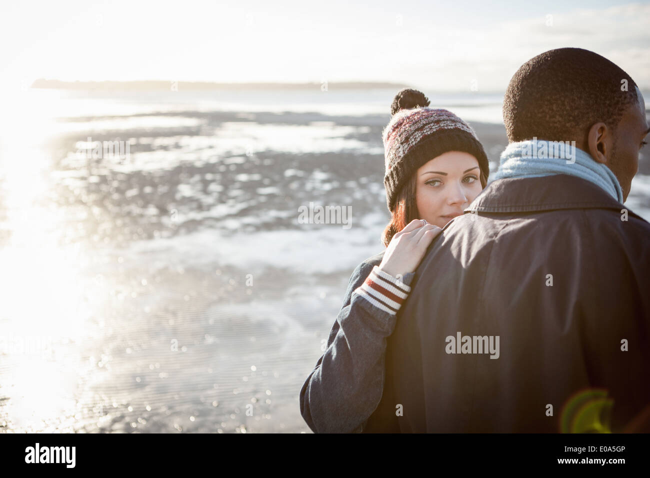 Romantic young couple walking on the beach Stock Photo