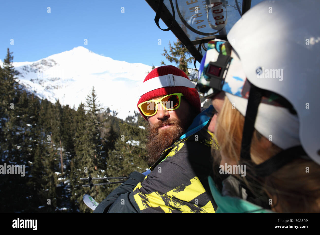 Snowboard and skiing couple on mountain, Mayrhofen, Tyrol, Austria Stock Photo