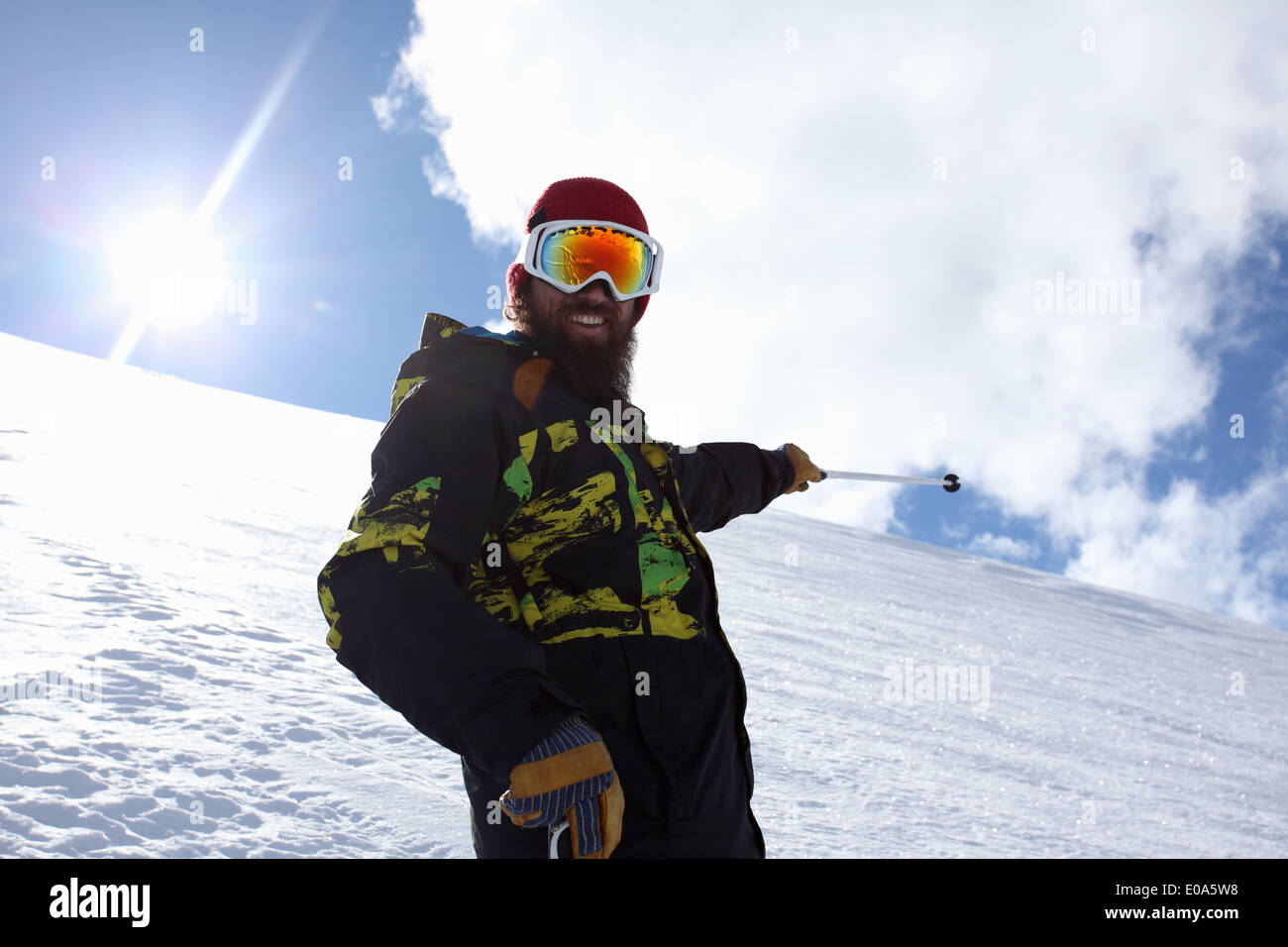 Mid adult man skier pointing at mountain, Mayrhofen, Tyrol, Austria Stock Photo