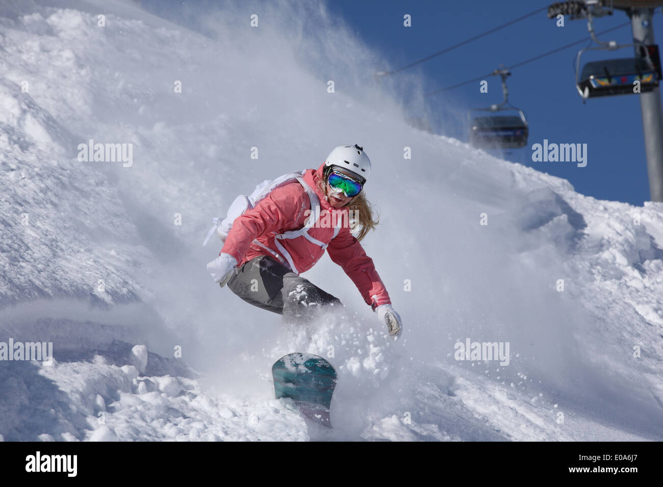 Young woman snowboarding on steep mountain, Hintertux, Tyrol, Austria Stock Photo