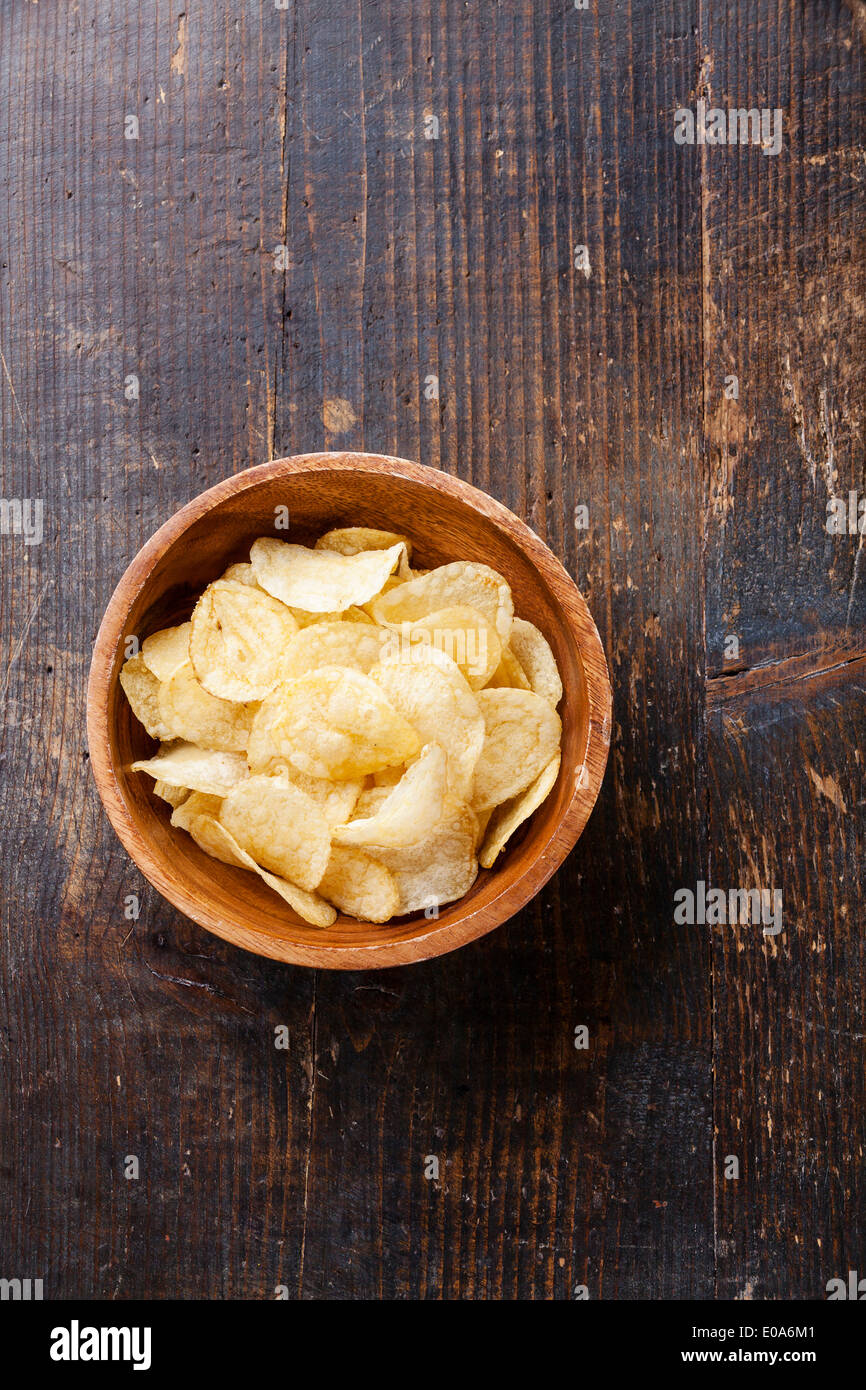 Crispy potato chips on wooden background Stock Photo