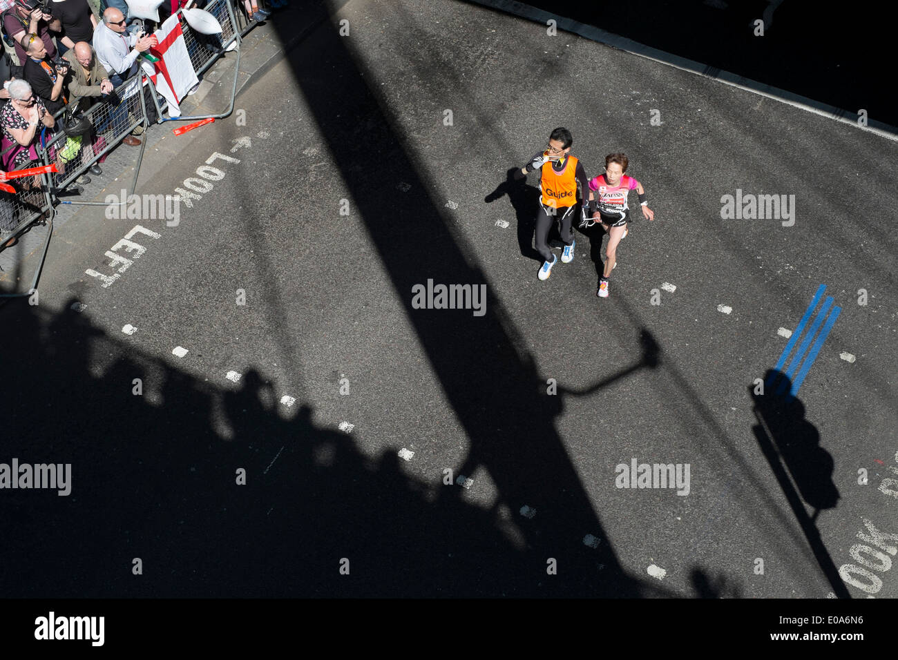 Competitors in the 2014 London Marathon. Visually impaired runner and guide. Stock Photo