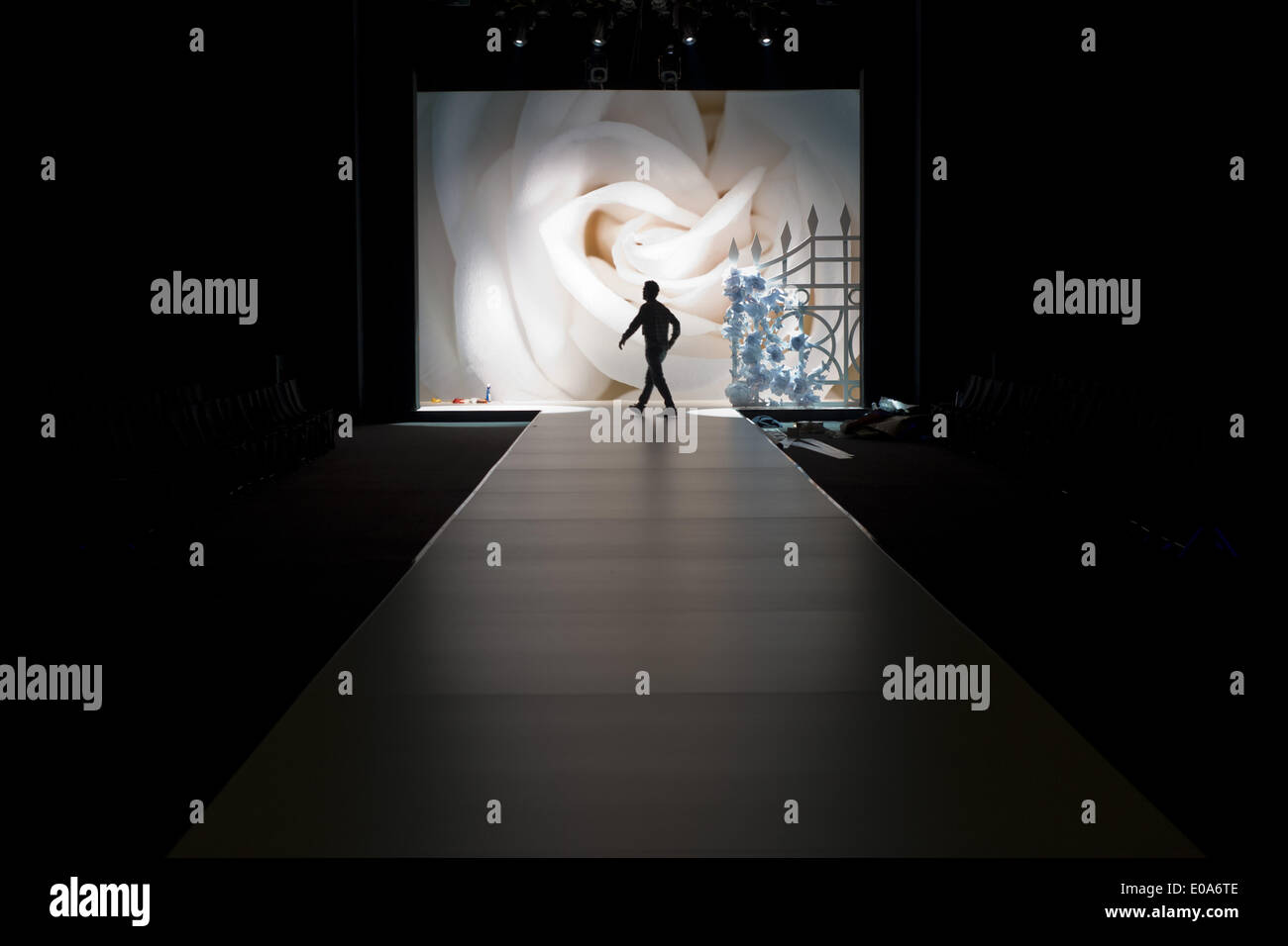 Barcelona, Spain. 7th May, 2014.   A human figure crosses in front of the image of a rose just before starting a bridal fashion show. Barcelona Bridal Week is a fashion industry event that includes Gaudi Novias (brides) Catwalk. Credit:  Jordi Boixareu/ZUMA Wire/ZUMAPRESS.com/Alamy Live News Stock Photo