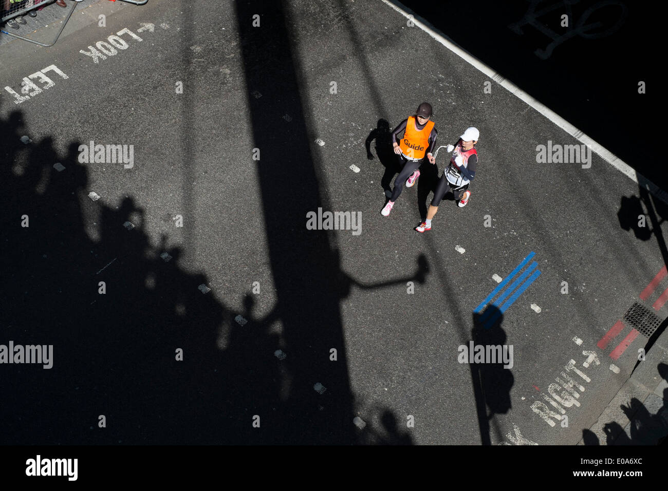 Competitors in the 2014 London Marathon. Visually impaired runner with their guide Stock Photo