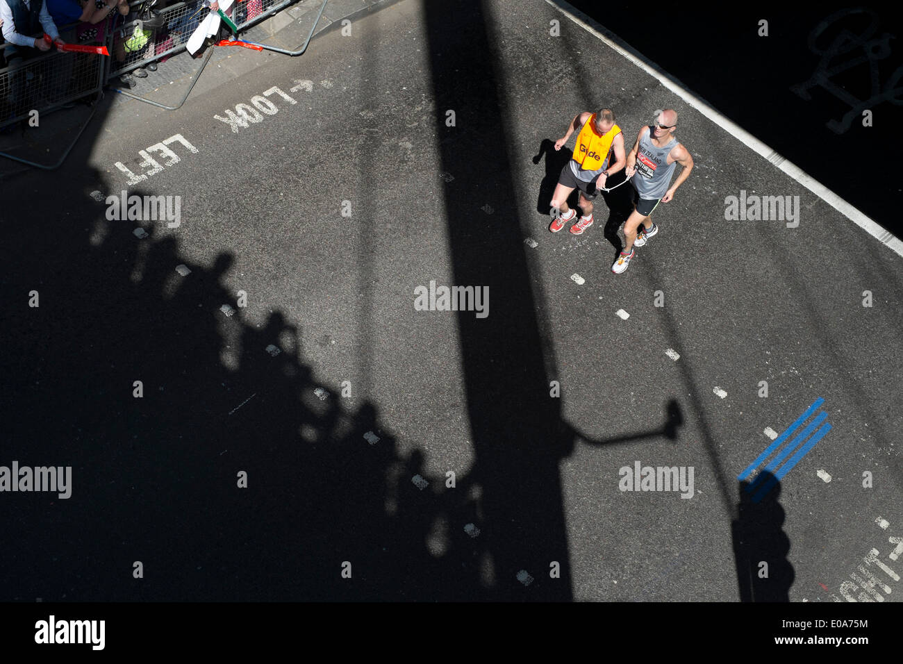 Competitors in the 2014 London Marathon. Visually impaired runner with their guide Stock Photo