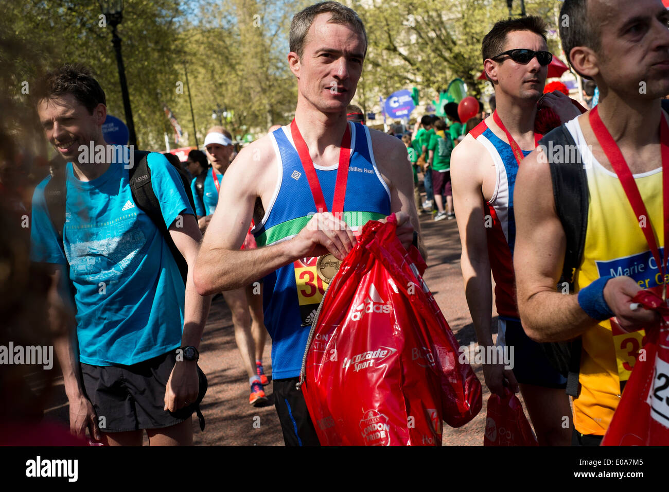 Competitors in the 2014 London Marathon. Runners with their medals and goody bags at the finish
