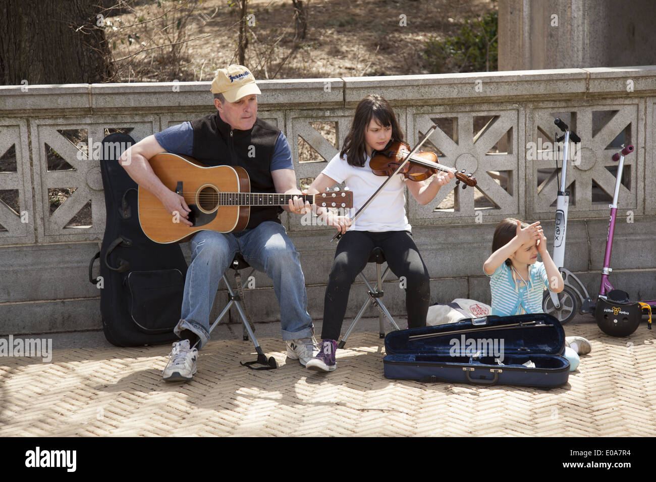 Family of troubadours play on the street near the farmers market at Grand Army Plaza in Brooklyn, NY. Stock Photo