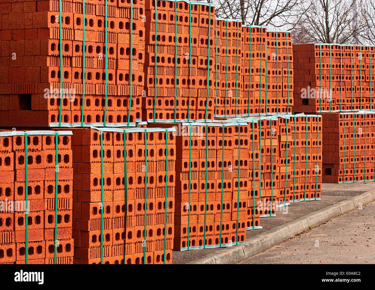 Delivery of red bricks a popular building material ready for the construction of a new home by Builders Stock Photo
