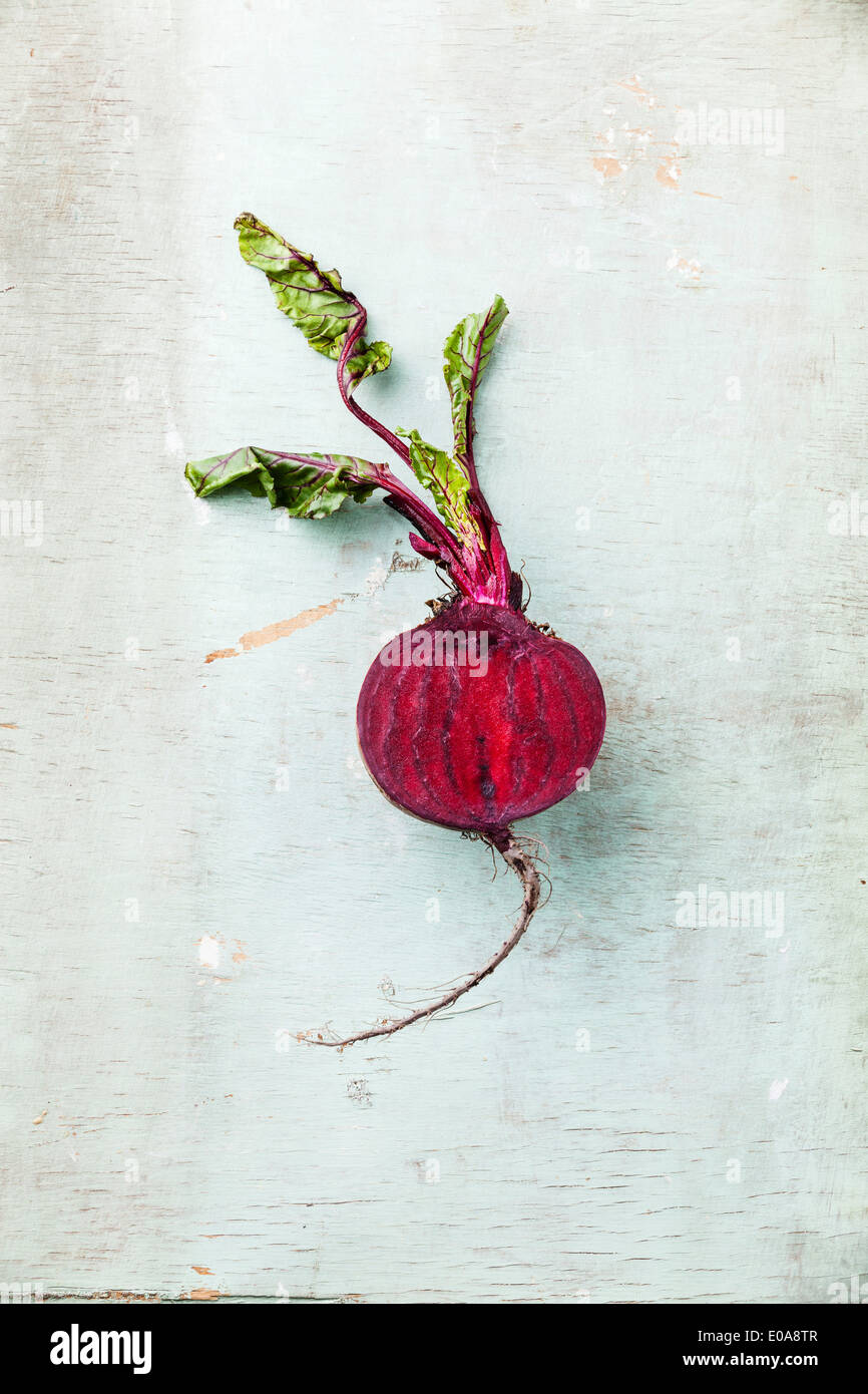 Ripe beet with leaves on textured background Stock Photo