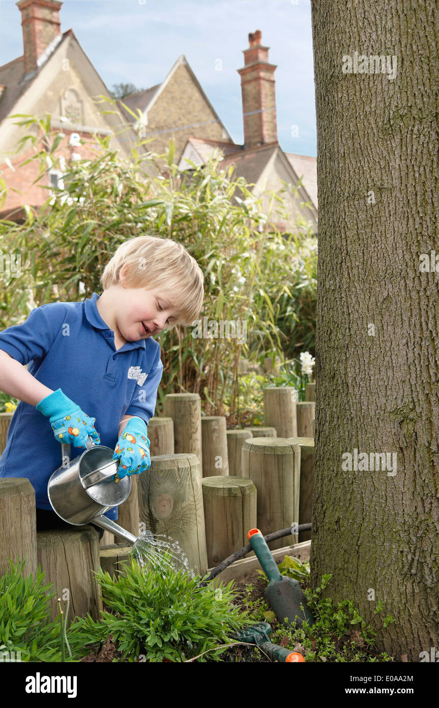 School boy watering plants in garden Stock Photo - Alamy