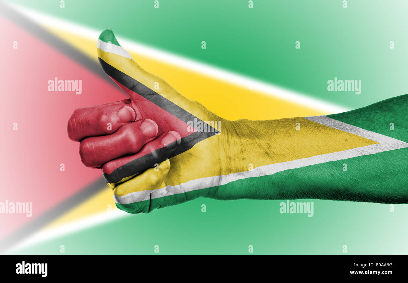 Old woman giving the thumbs up sign  isolated  flag of Guyana Stock Photo