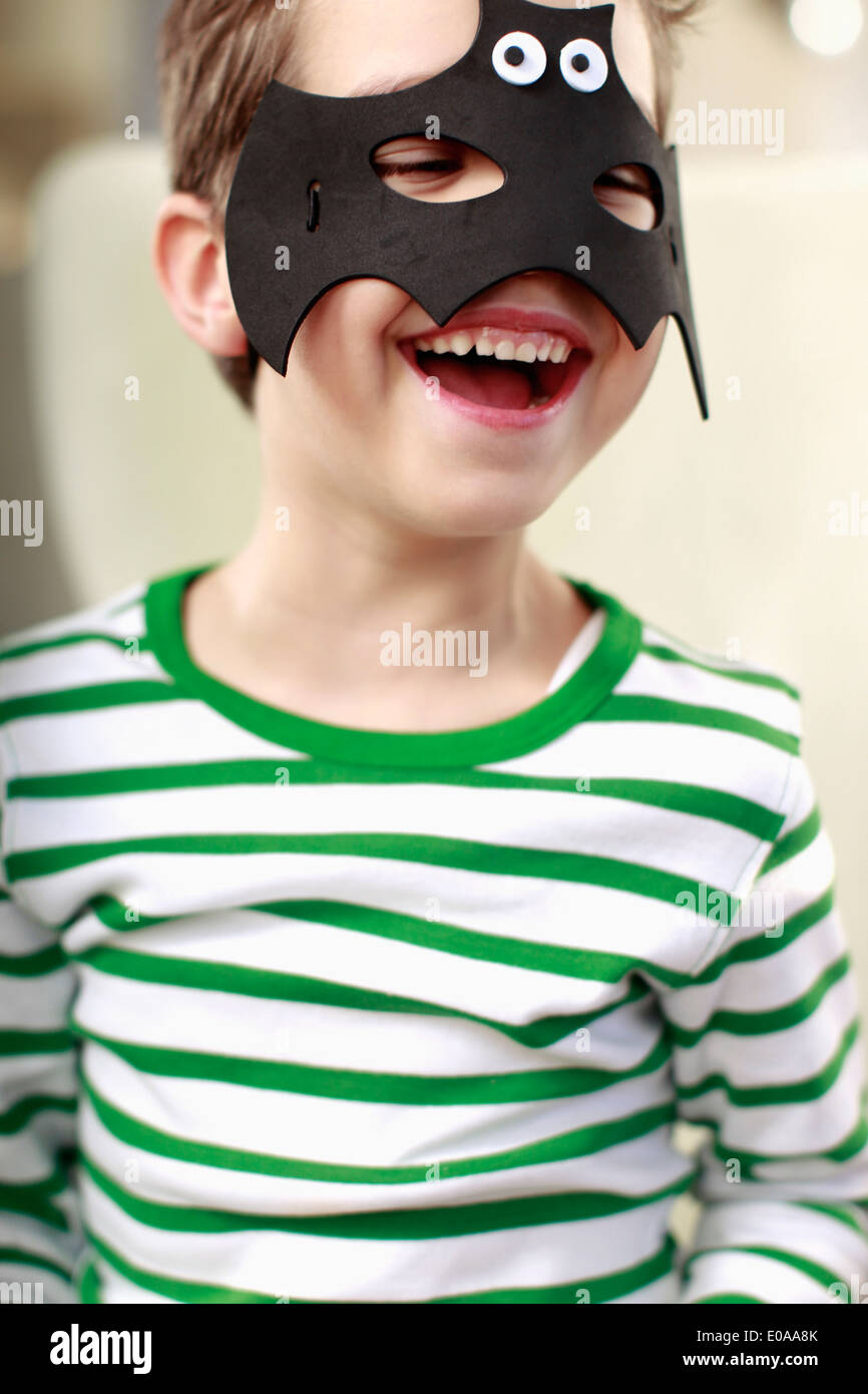 Portrait of young boy in bat mask Stock Photo