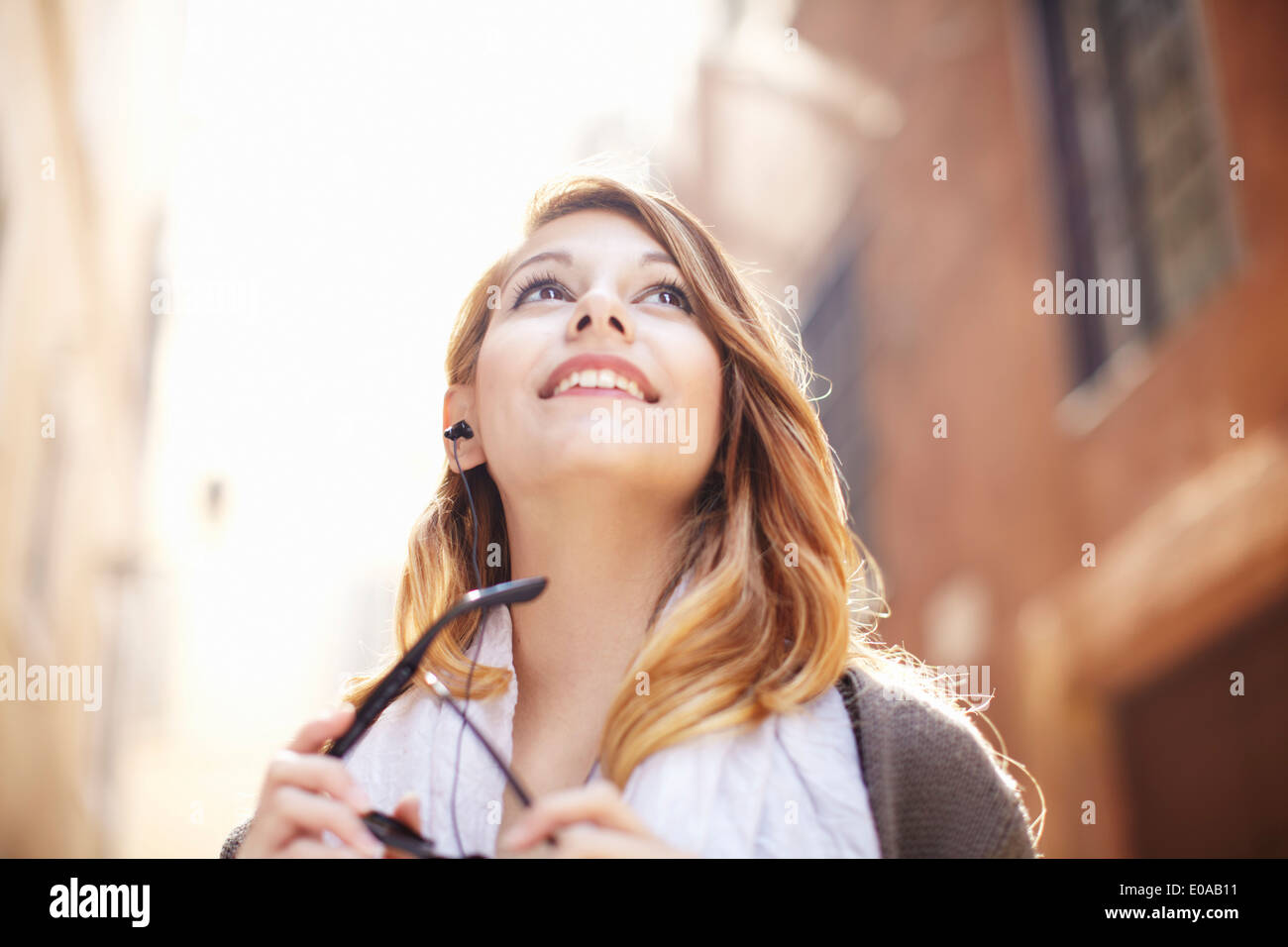 Young woman looking up at buildings, Rome, Italy Stock Photo