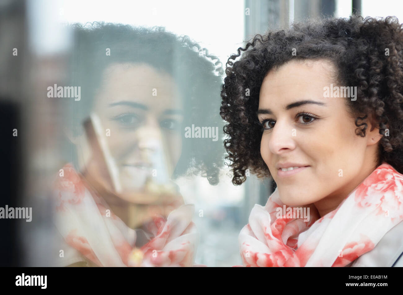 Close up portrait of young woman window shopping Stock Photo