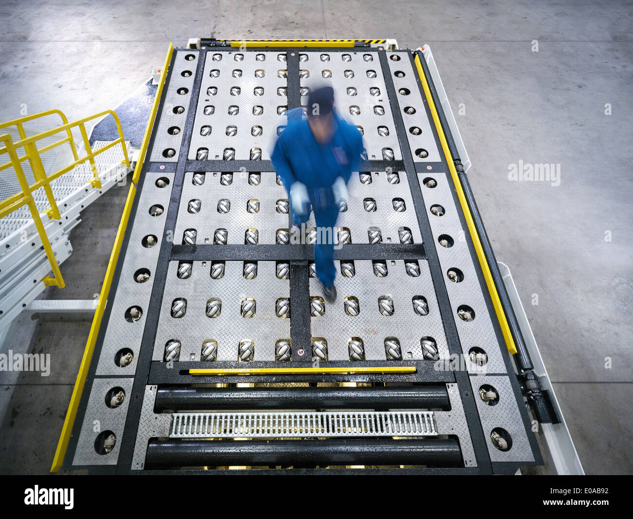 Engineer inspects baggage handling truck in truck repair factory Stock Photo