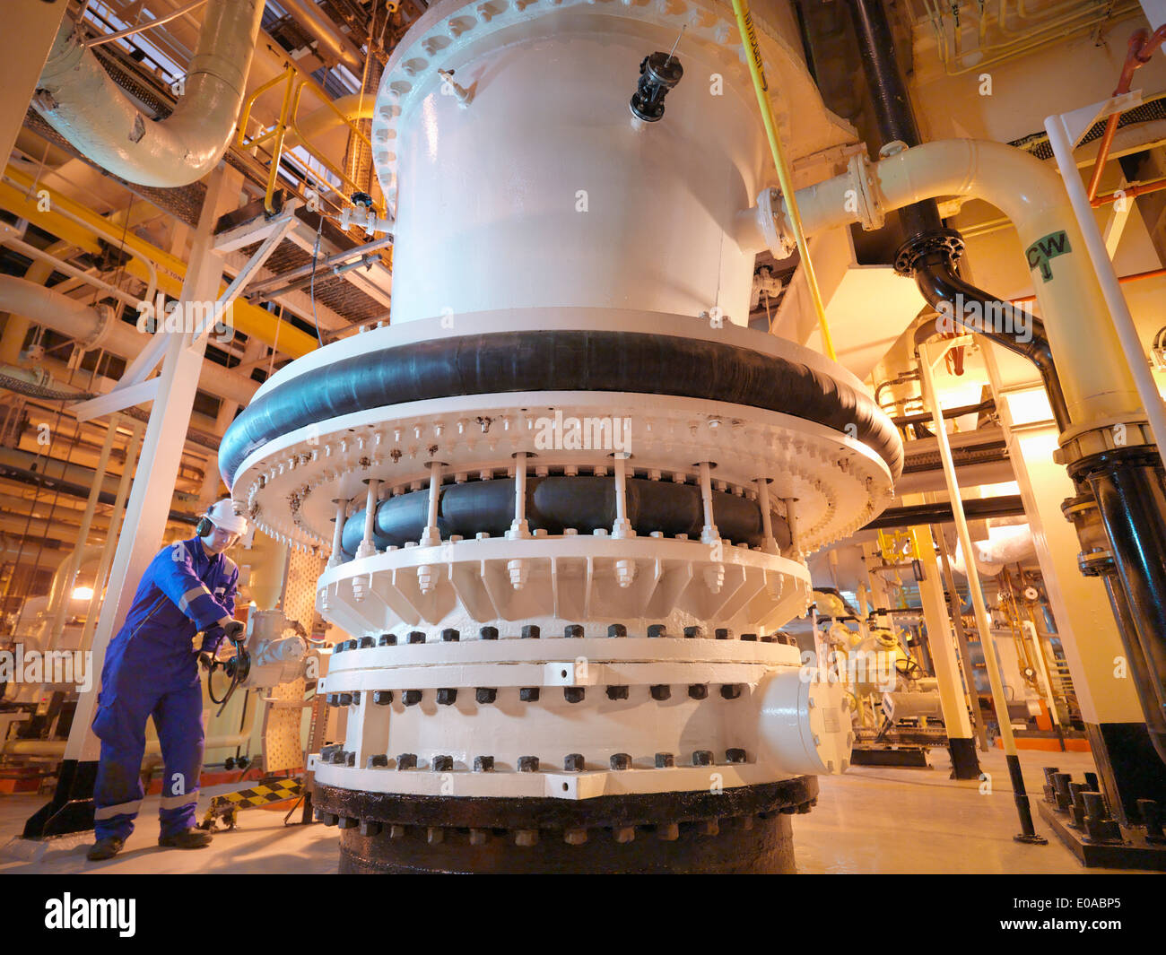 Engineer adjusting seawater valve in power Stock Photo