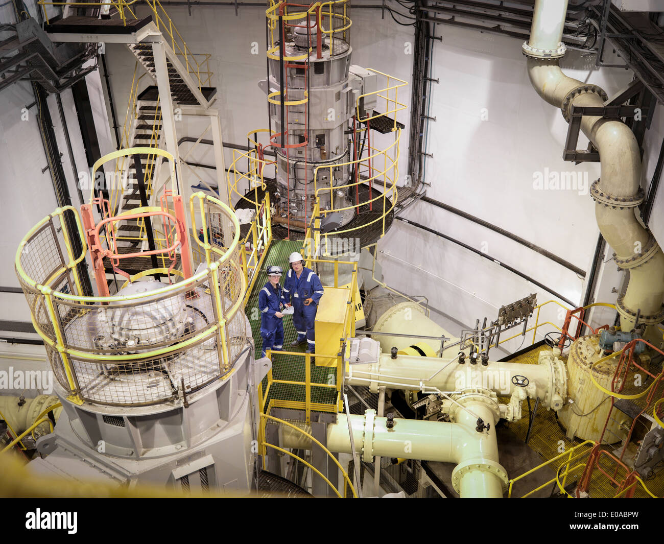 Engineers in seawater pumping station of power station, high angle view Stock Photo