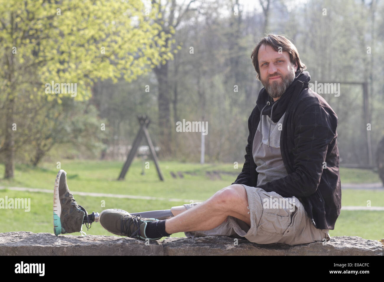 Portrait of man with prosthesis leg in park Stock Photo
