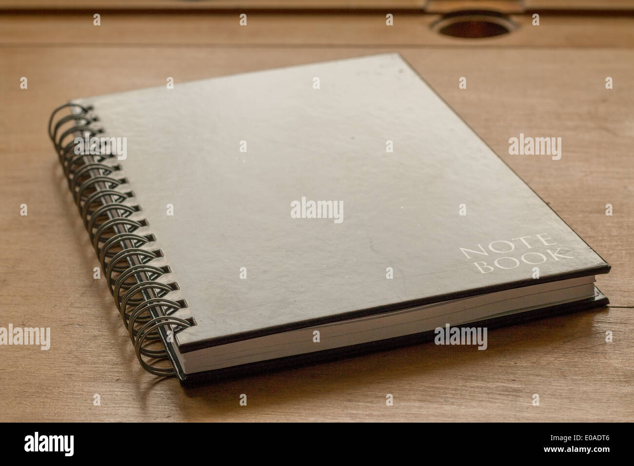Closed notebook on a old wooden school desk Stock Photo