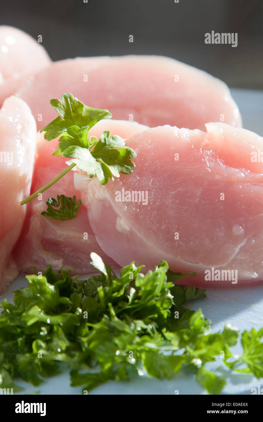 Lean chicken pieces with chopped parsley Stock Photo - Alamy