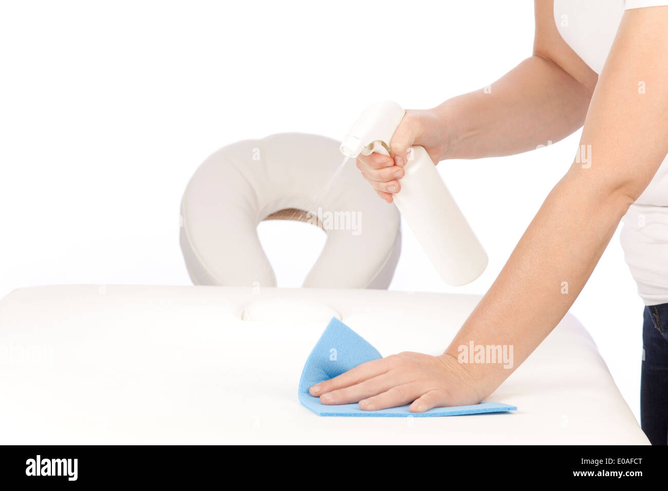 Disinfecting a massage table Stock Photo