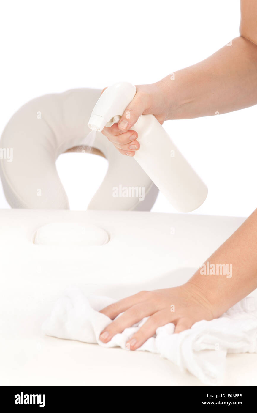 Disinfecting a massage table Stock Photo